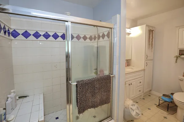 a bathroom with a shower and a sink