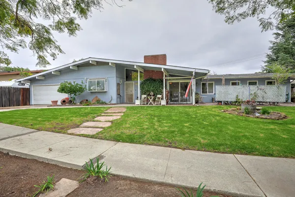 a front view of house with yard and green space
