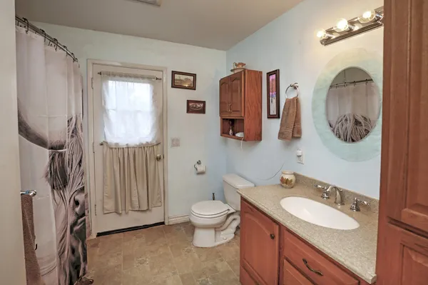 a bath room with a toilet sink and a mirror