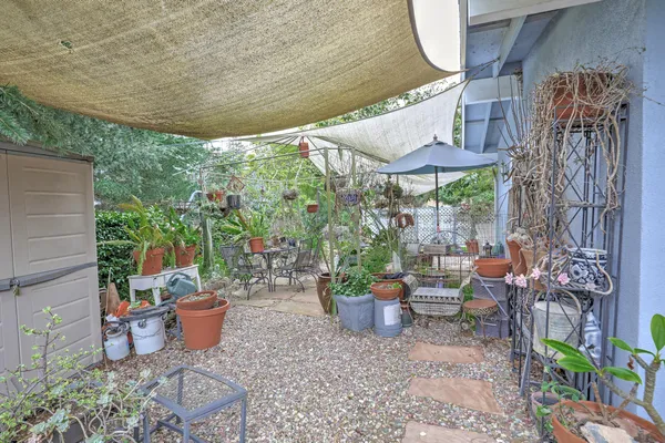 a view of a patio with table and chairs potted plants