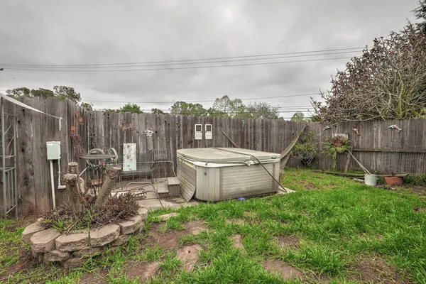 a view of a backyard with table and chairs potted plants