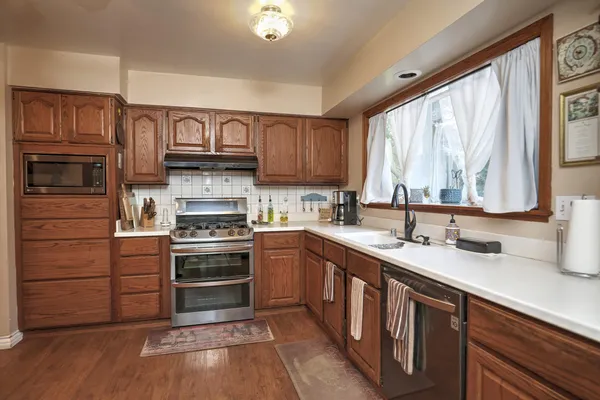 a kitchen with a sink stove and cabinets