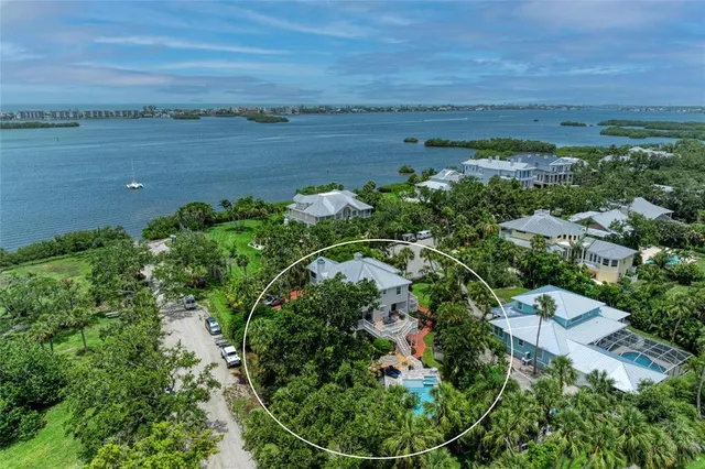 an aerial view of a houses with outdoor space and river
