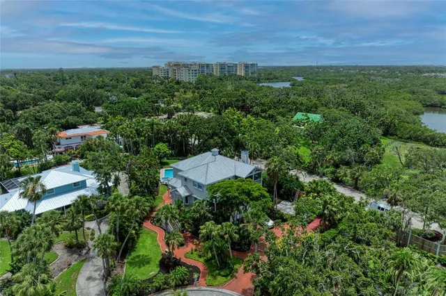 an aerial view of a house with a yard and pool