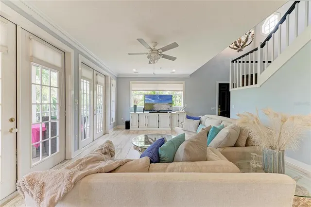 a living room with furniture and a chandelier