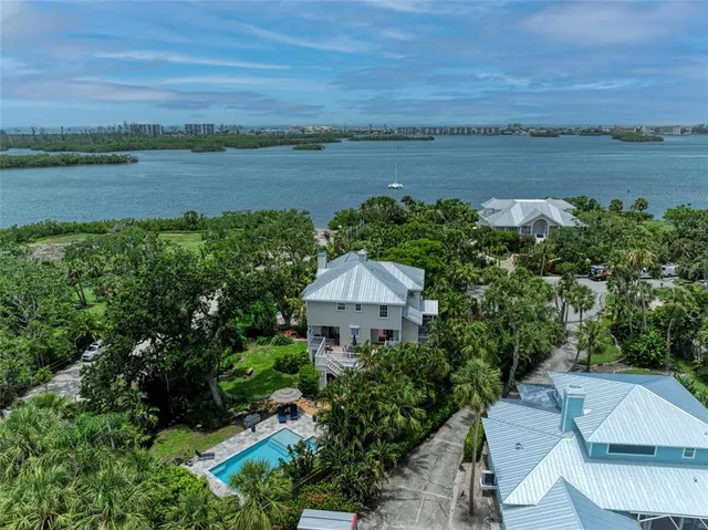 an aerial view of a houses with outdoor space and lake view