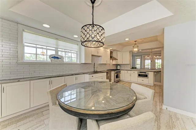 a view of an outdoor dining space with a table and chairs