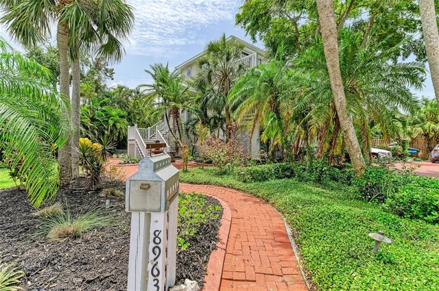 a living room with furniture and a ceiling fan