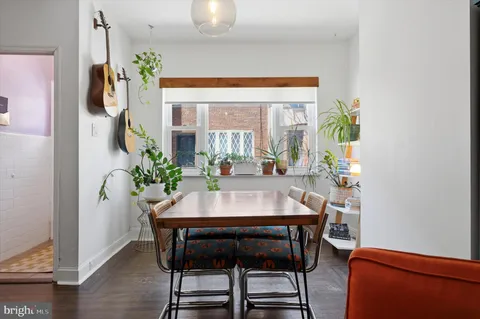 a view of a dining room with furniture and a potted plant