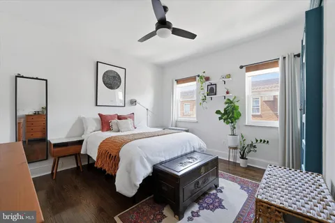 a bedroom with a bed a chandelier and a window
