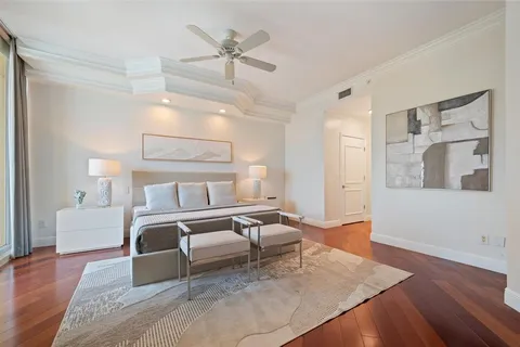 a bedroom with a large bed and a chandelier