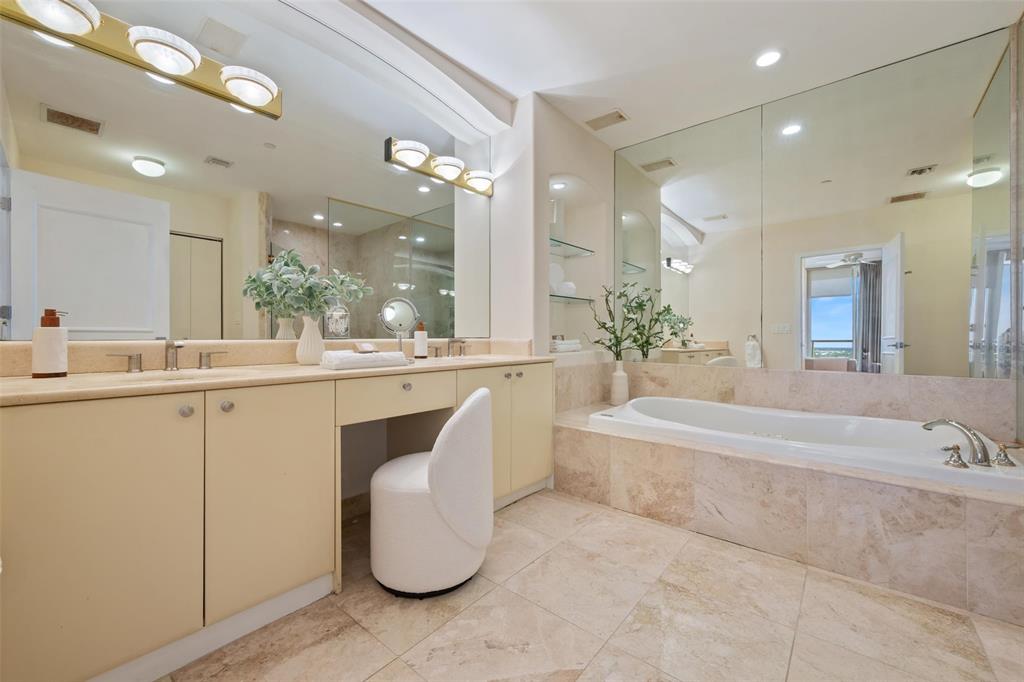 2100 North Ocean Boulevard, Unit 20D Fort Lauderdale, FL 33305 - Photo 17 of 25 a bathroom with a tub a sink and mirror