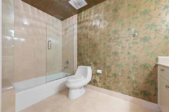 a bathroom with a shower toilet and sink