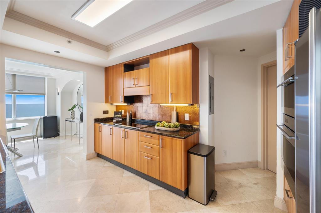 2100 North Ocean Boulevard, Unit 20D Fort Lauderdale, FL 33305 - Photo 5 of 25 a kitchen with stainless steel appliances granite countertop a stove a sink and a refrigerator
