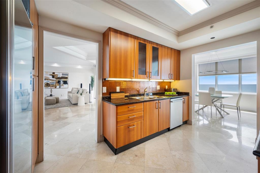 2100 North Ocean Boulevard, Unit 20D Fort Lauderdale, FL 33305 - Photo 7 of 25 a kitchen with stainless steel appliances granite countertop a stove a sink and a refrigerator