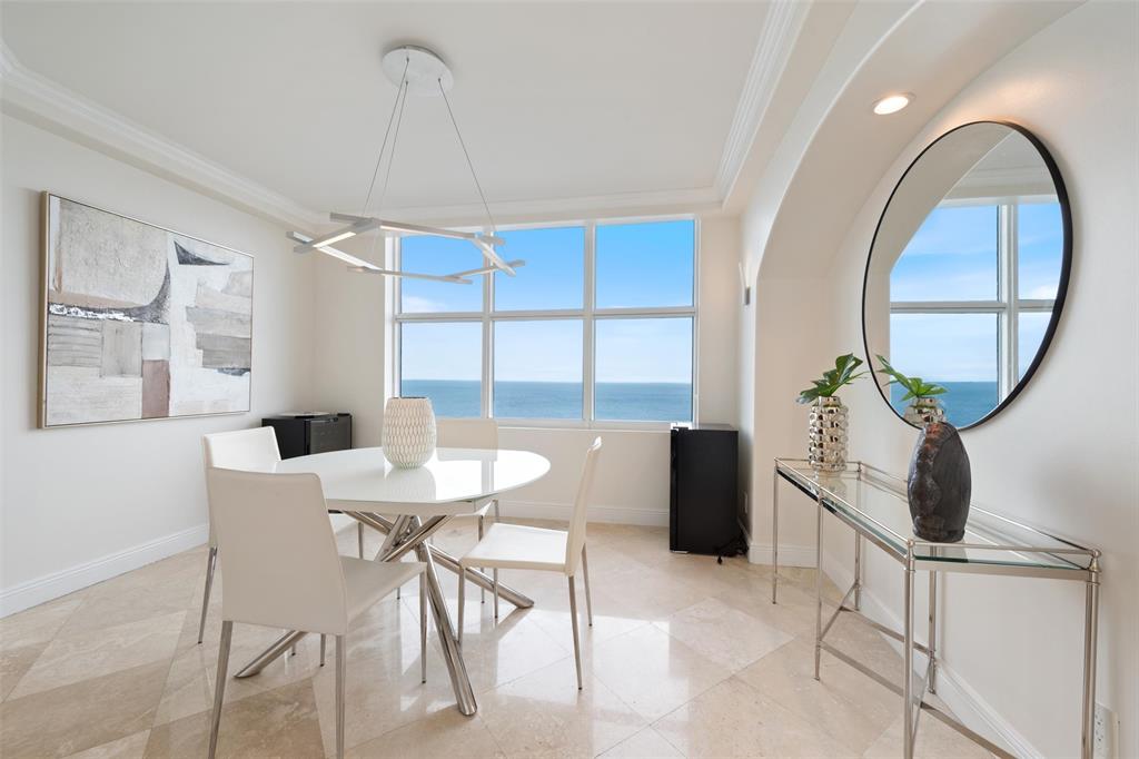 2100 North Ocean Boulevard, Unit 20D Fort Lauderdale, FL 33305 - Photo 10 of 25 a view of a dining room with furniture window and wooden floor