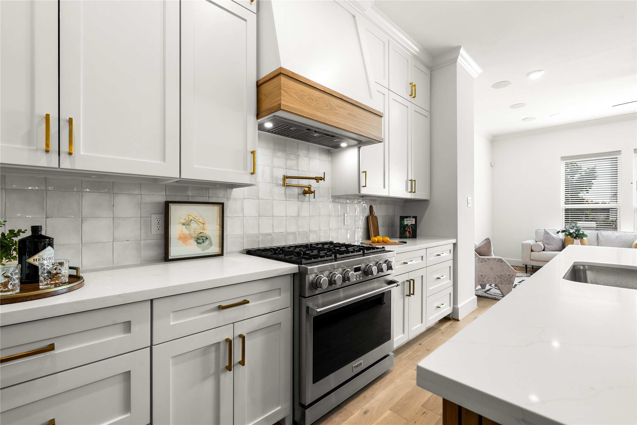 1614 Ojeman Road, Unit E Houston, TX 77055 - Photo 17 of 50 This gourmet kitchen is equipped with a premium Thor 6-burner gas range, complemented by a sleek pot filler and custom wood-accented vent hood - blending luxury, functionality, and timeless design.