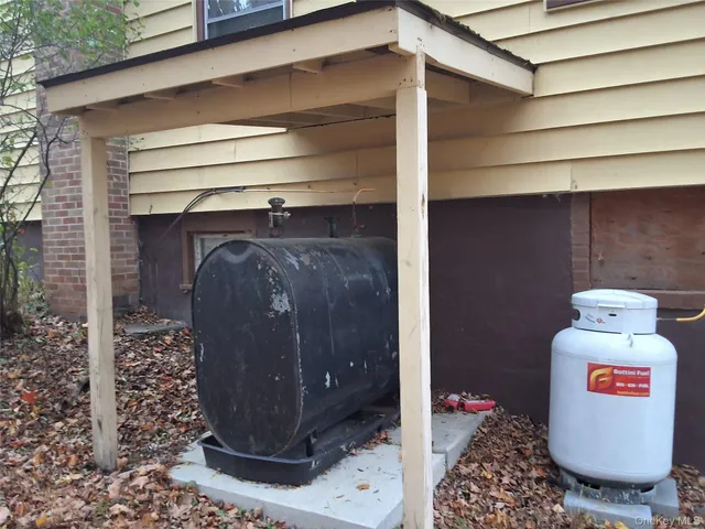 a view of a dirt road with large trees