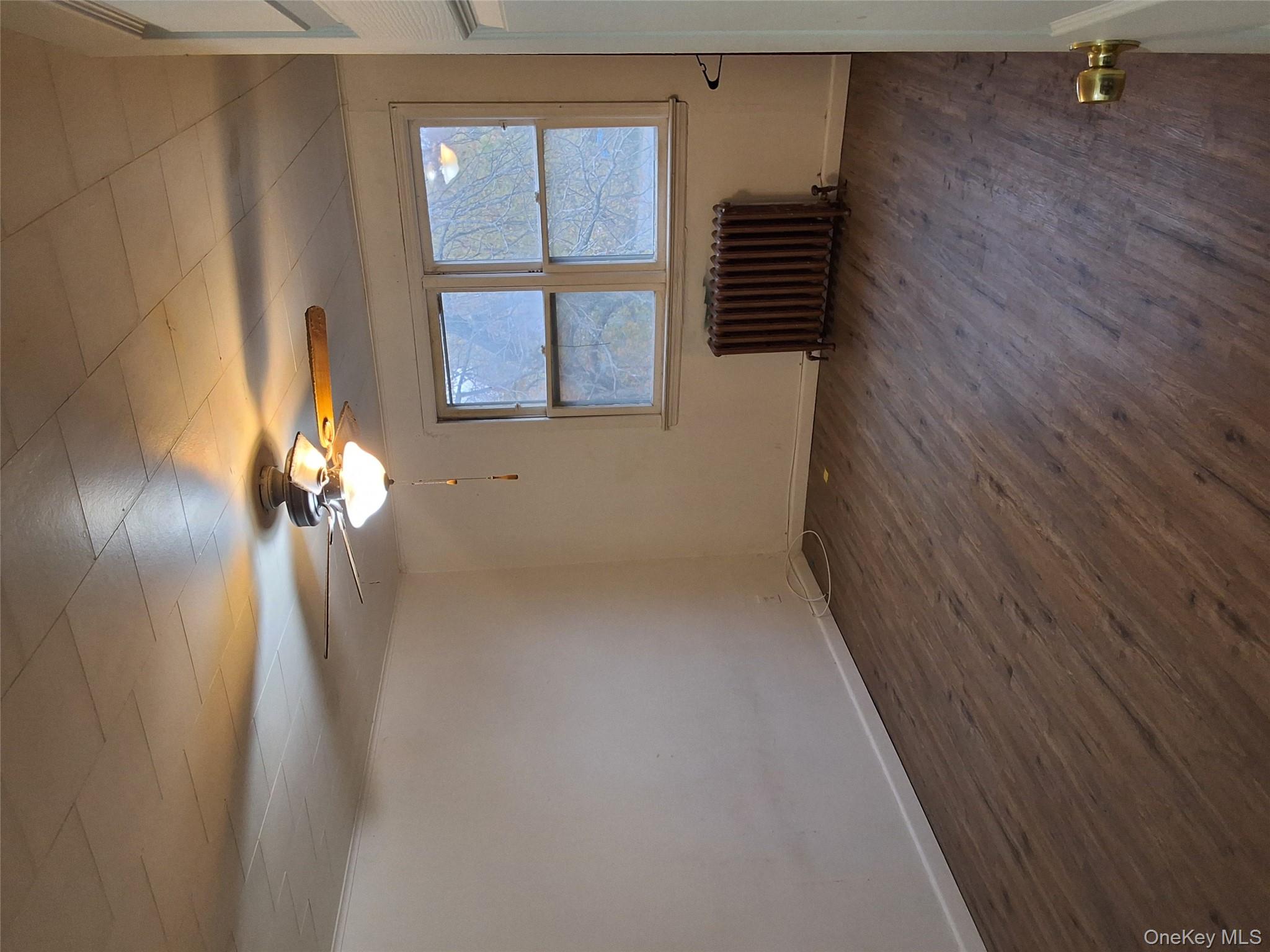 84 North Road Bloomingburg, NY 12721 - Photo 4 of 14 a view of an empty room with a window and wooden floor