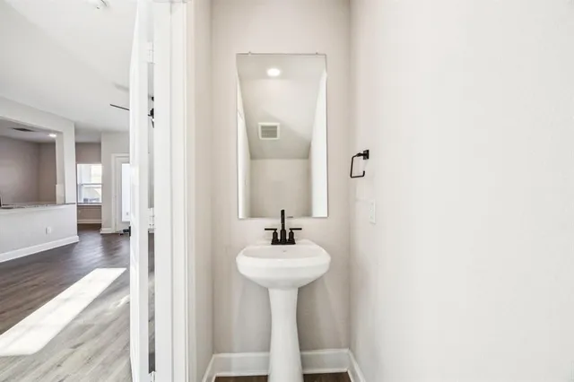 a bathroom with a sink a mirror and a bathtub