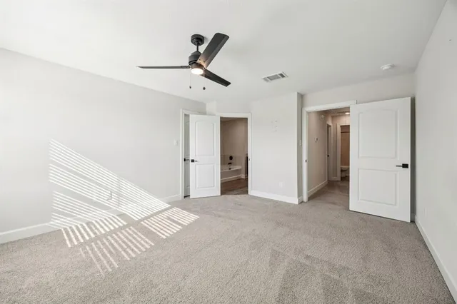 a view of a livingroom with a ceiling fan and entryway