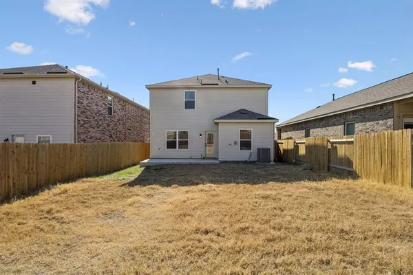 a view of garage and wooden fence