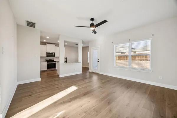 a view of kitchen with furniture and wooden floor