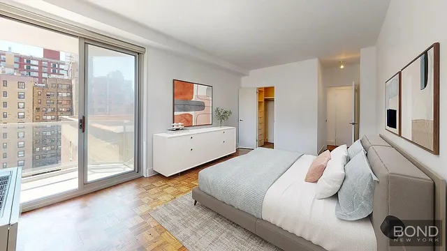 a bedroom with a bed and a large window