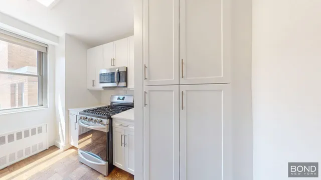 a view of a kitchen with appliances and cabinets