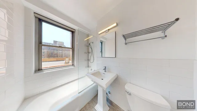 a bathroom with a sink a toilet and a mirror