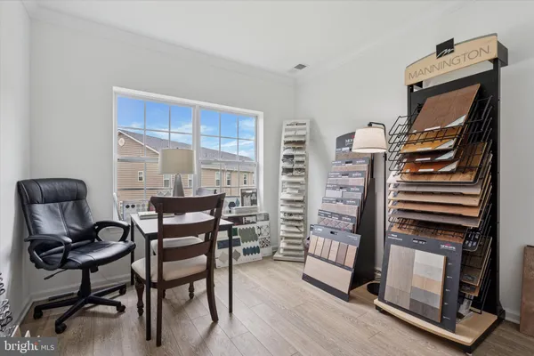 a kitchen with stainless steel appliances granite countertop a refrigerator a stove and a sink with wooden floors