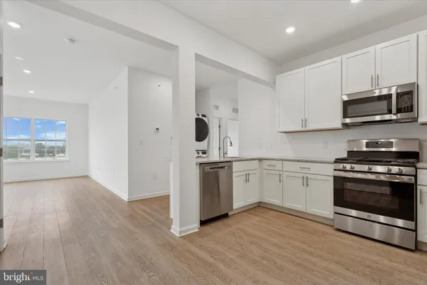 a kitchen with cabinets stainless steel appliances and a sink