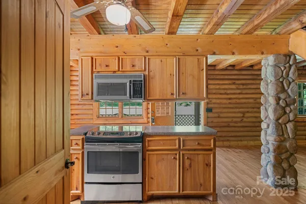 a kitchen with stainless steel appliances granite countertop a stove and a microwave