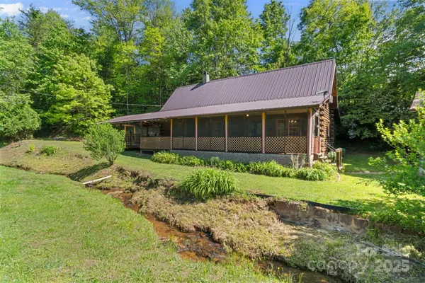 a front view of a house with a garden and plants