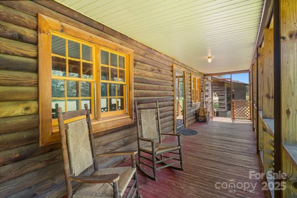 a view of a porch with a table and chairs and wooden floor