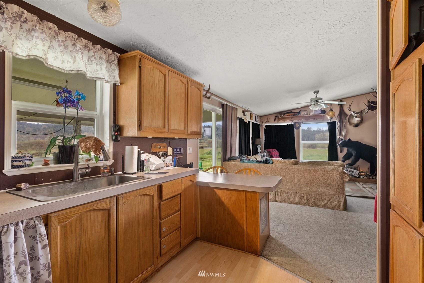 1503 Lincoln Creek Road Rochester, WA 98579 - Photo 11 of 28 a kitchen with sink and refrigerator