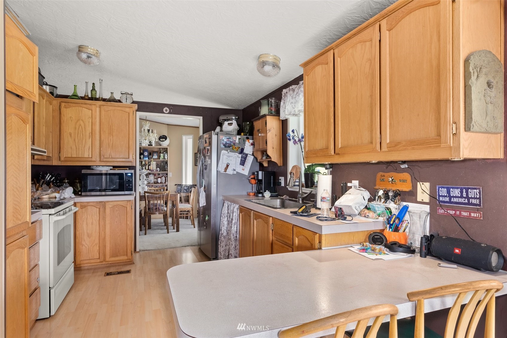 1503 Lincoln Creek Road Rochester, WA 98579 - Photo 20 of 28 a kitchen with stainless steel appliances a refrigerator and a stove top oven
