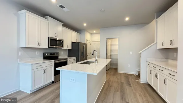 a kitchen with a sink stove and refrigerator