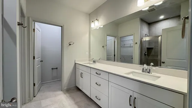 a bathroom with a glass shower door