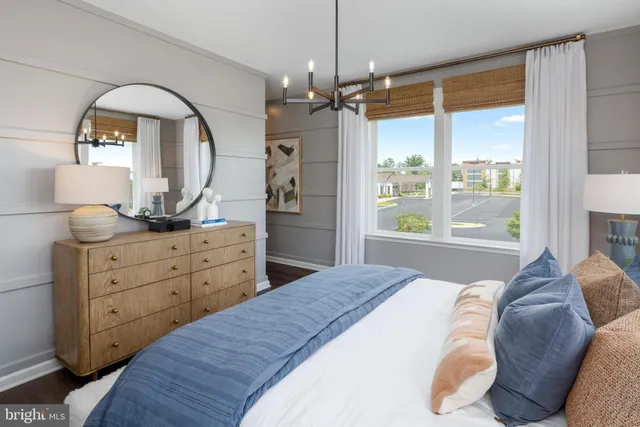 a bedroom with a large bed and a dresser