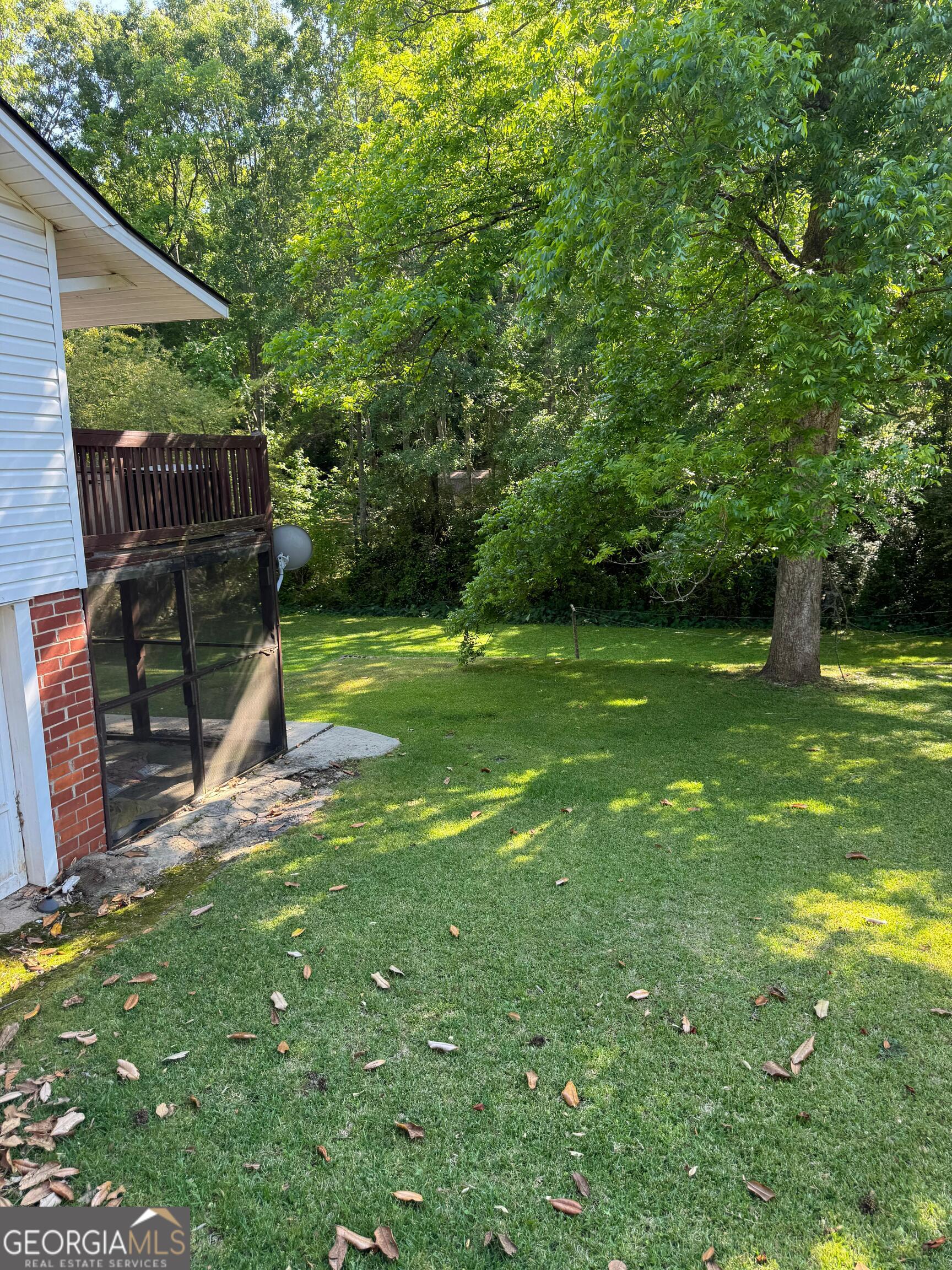 609 West Main Street Thomaston, GA 30286 - Photo 3 of 27 a view of a backyard with a slide