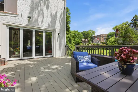 a view of a two chairs and table in the patio