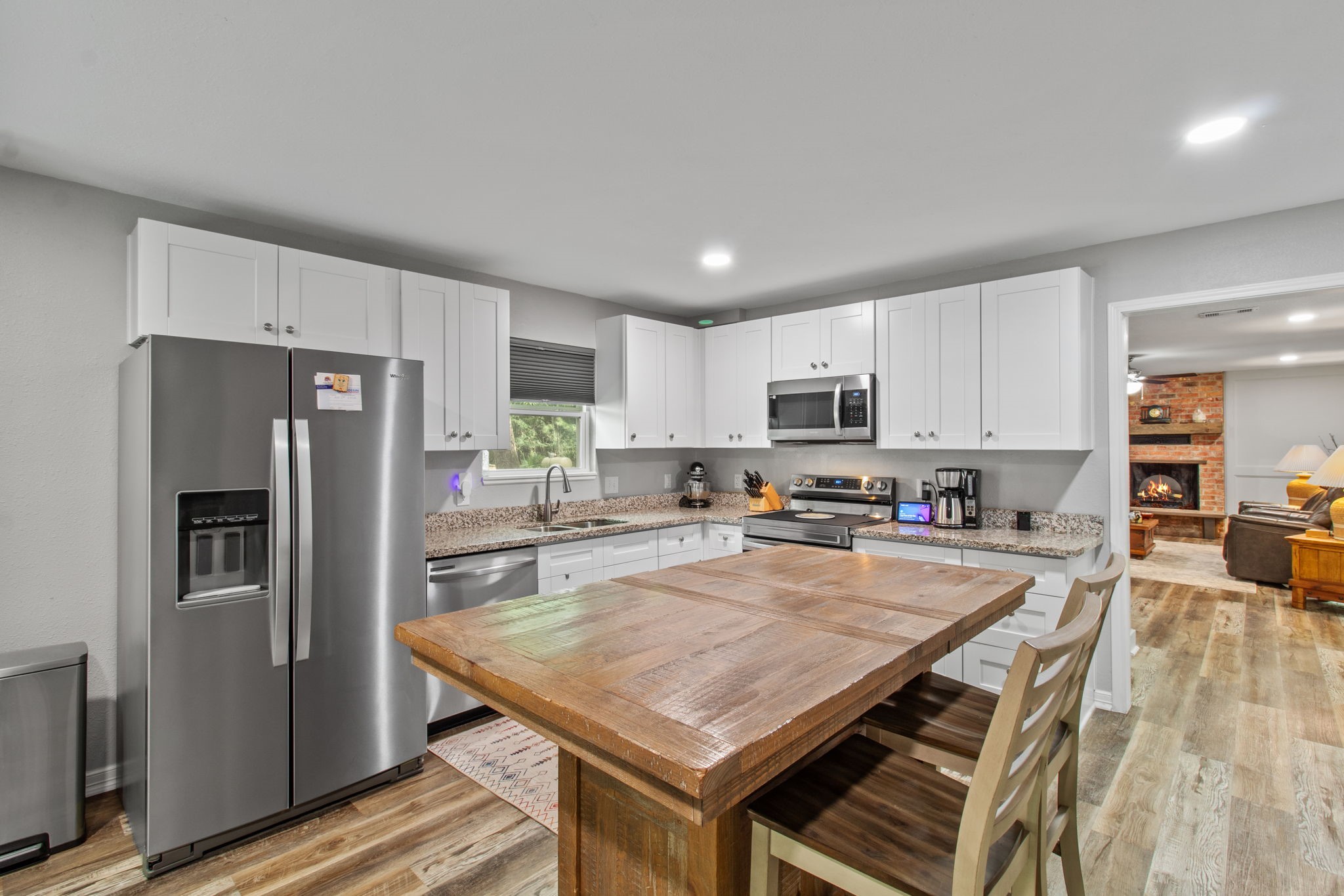 21 Red Oak Circle Point Blank, TX 77364 - Photo 22 of 50 a kitchen with a refrigerator a stove top oven a sink and cabinets