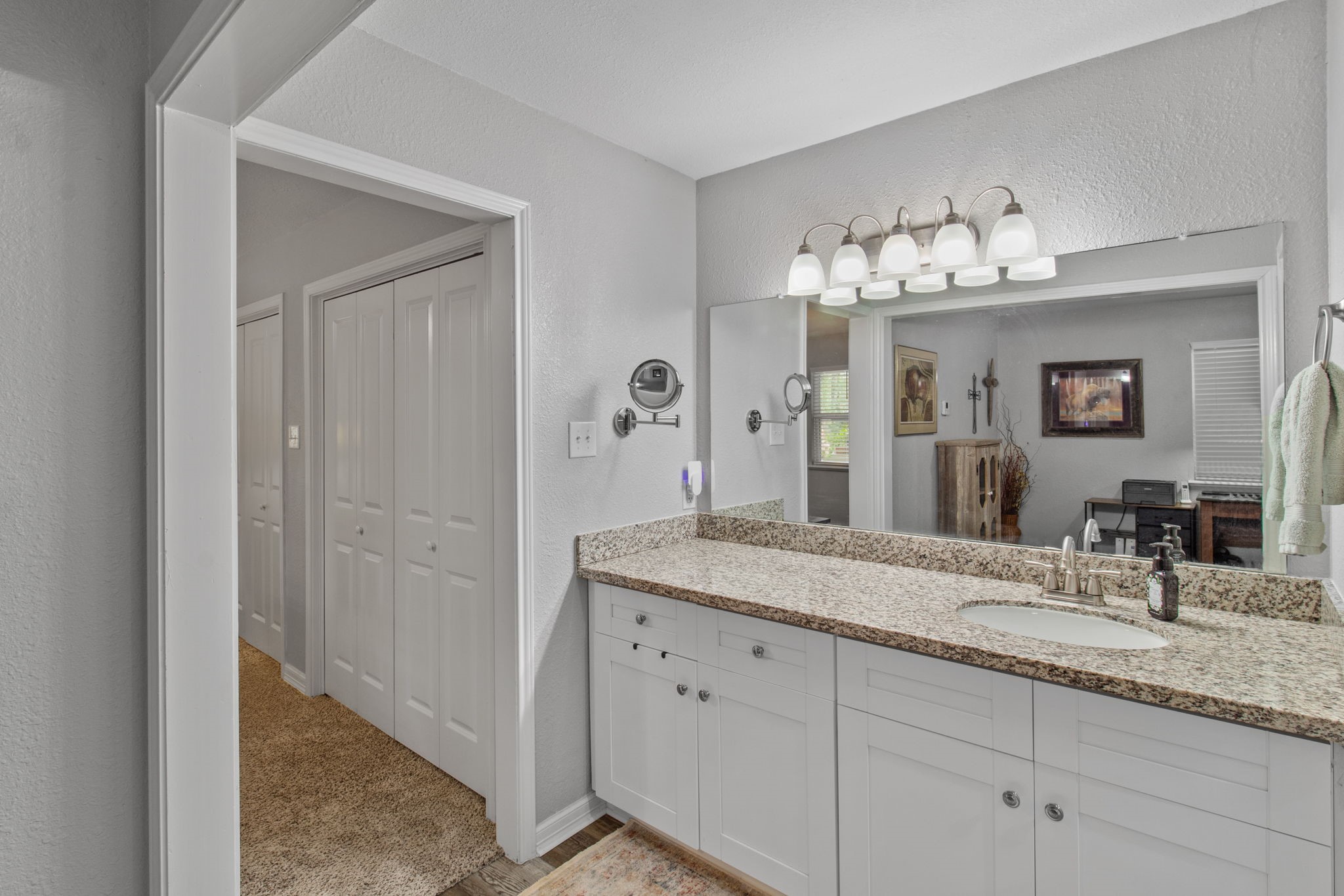 21 Red Oak Circle Point Blank, TX 77364 - Photo 31 of 50 a bathroom with a granite countertop sink and a mirror