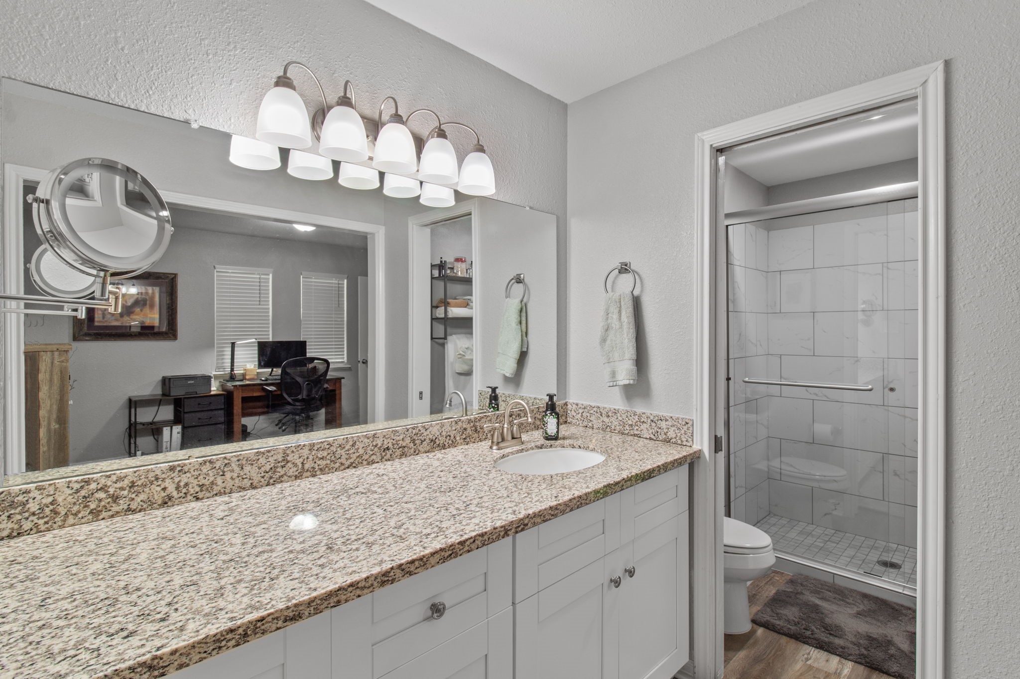 21 Red Oak Circle Point Blank, TX 77364 - Photo 32 of 50 a bathroom with a granite countertop double vanity sink and a mirror