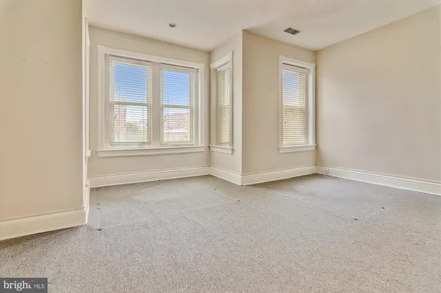 a spacious bathroom with a granite countertop sink a mirror and a vanity
