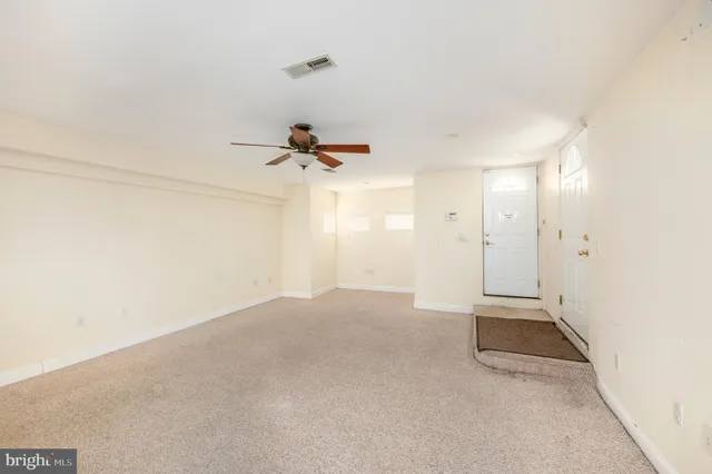 a kitchen with refrigerator and cabinets