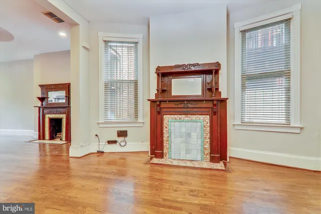 a view of a livingroom with a fireplace and window