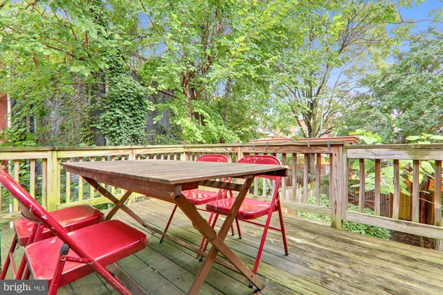 an outdoor sitting area with furniture and wooden floor