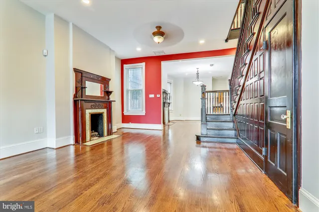 a view of entryway and hall with wooden floor